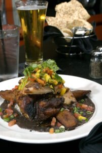 Festive-jerk-chicken-with-black-beans,-rice-and-plantains